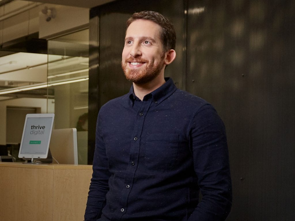 Jonathan Becker standing in his company office.