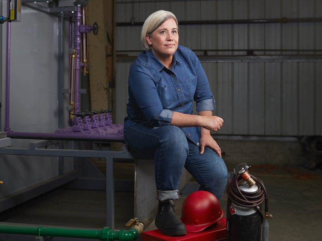 Tamara Pongracz seated with trades tools