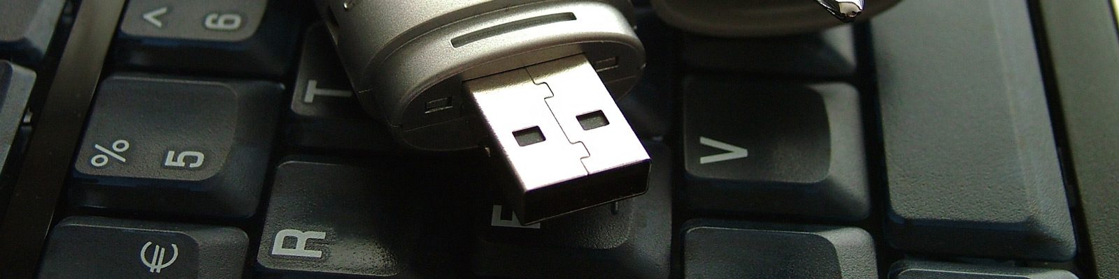 close up of a usb stick on a computer keyboard.