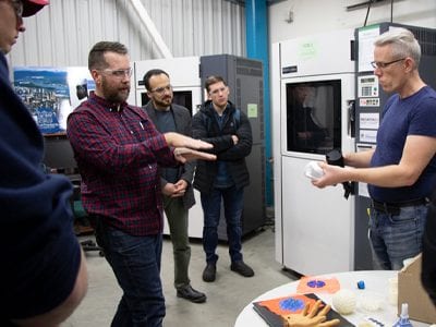 Student and rsearcher interact on tour of CARI lab