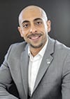Arash Salamati smiling in gray jacket
