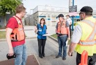 Disaster personnel listening to a person giving direction.