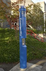 Emergency phone blue pole in parking lot.