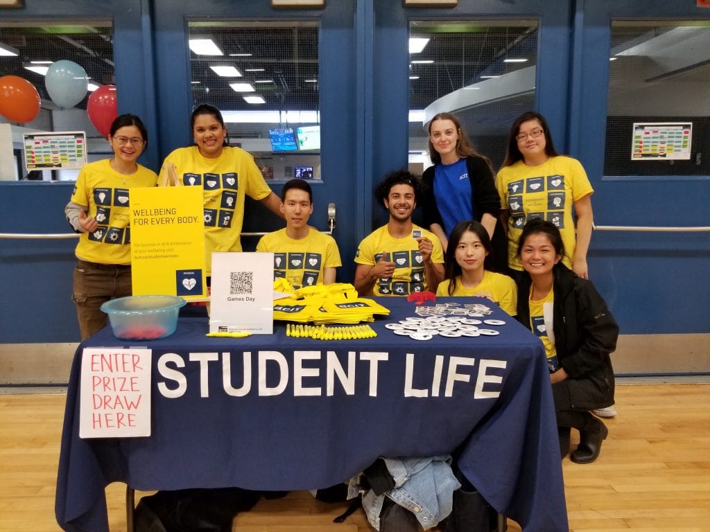 group of student life ambassadors in yellow t-shirts at a games day event