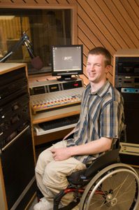 Man in wheelchair at a dj booth.