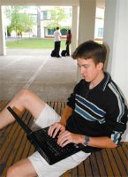 guy sitting down with an open laptop.