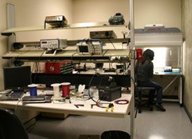 Person sitting at a computer in the alpha lab.