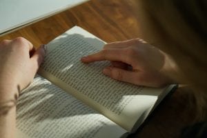 hands holding an open book