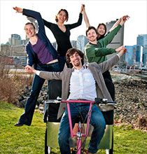 Photo of grace soo and her four team mates riding a zero-emission cargo tricycle.