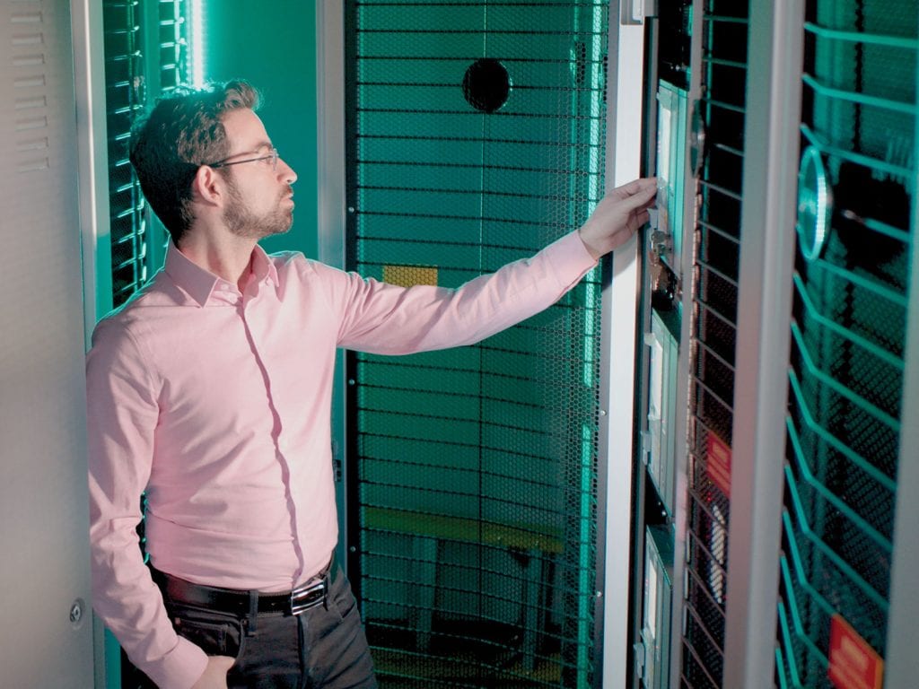 Man looking at control panel in a server room