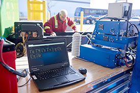 Emission reduction equipment with a tech working at a table.