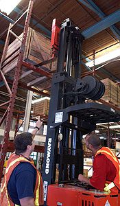 people working a forklift.