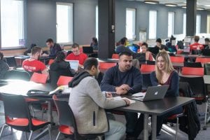 students studying together at a long table