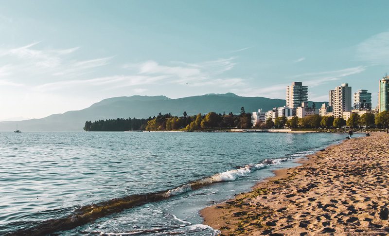 Vancouver landscape of beach, city and mountains.