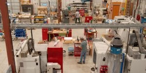 overhead view of warehouse with people working on a a variety of equipment