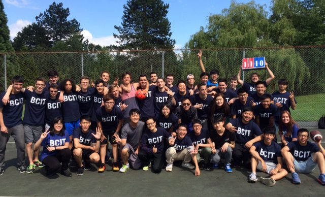 Group of international students in sports gear posing for a group photo.