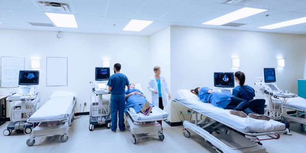 Students and instructor performing ultrasounds