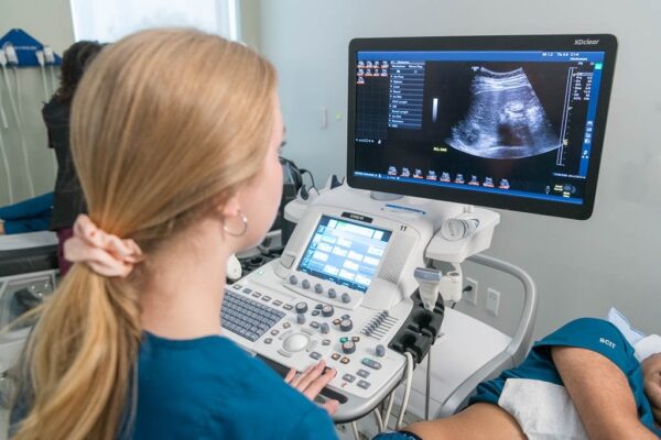 sonography student reviewing images