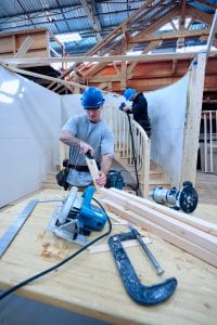 carpentry students cutting lumber