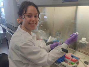 woman in a lab coat; working in a lab.