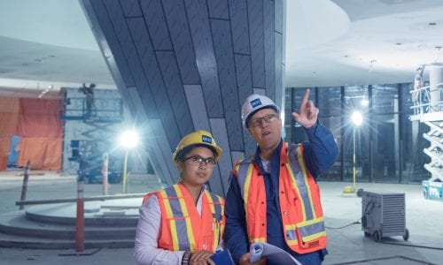 Instructor and student wearing hard hats and safety vests