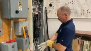 man demonstrating proper safety measures with electrical wiring