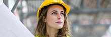 woman with blonde hair in yellow hardhat