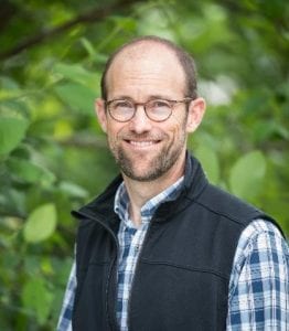 Eric Anderson in a green background