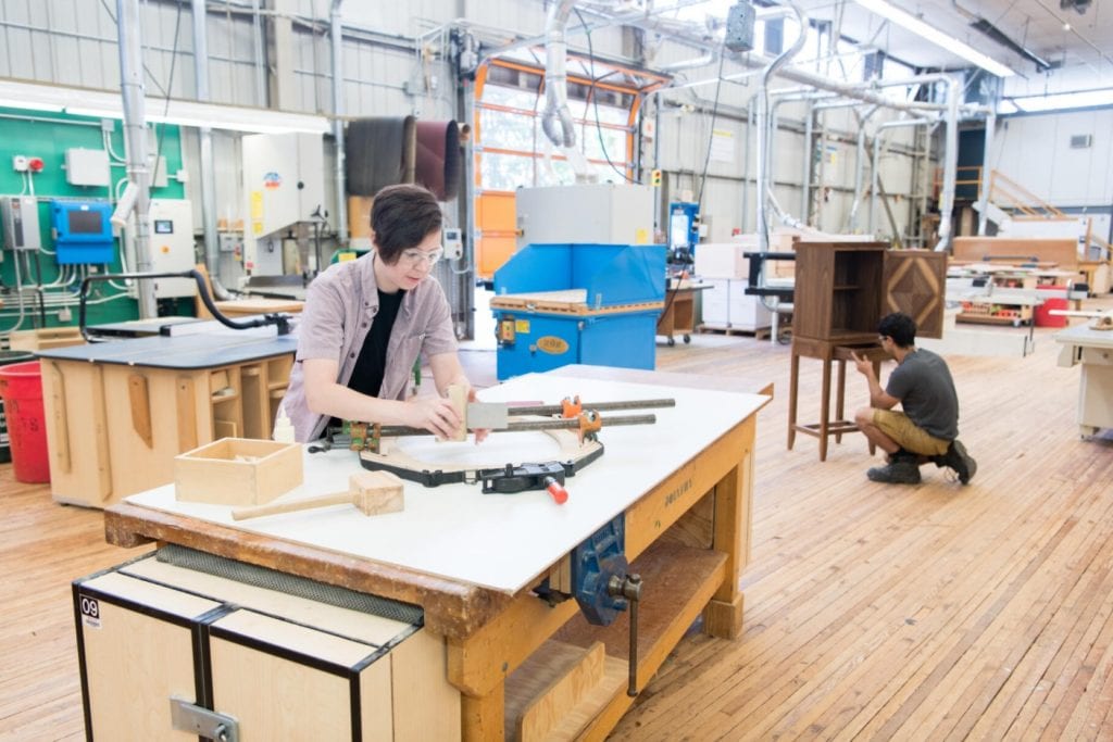 two students doing woodwork at a joinery shop