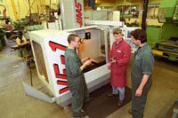 three people stood in front of a machine