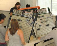 students looking at mechanical panels