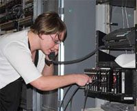 female working on some type of electronic panel