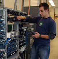 male in blue shirt looking at servers