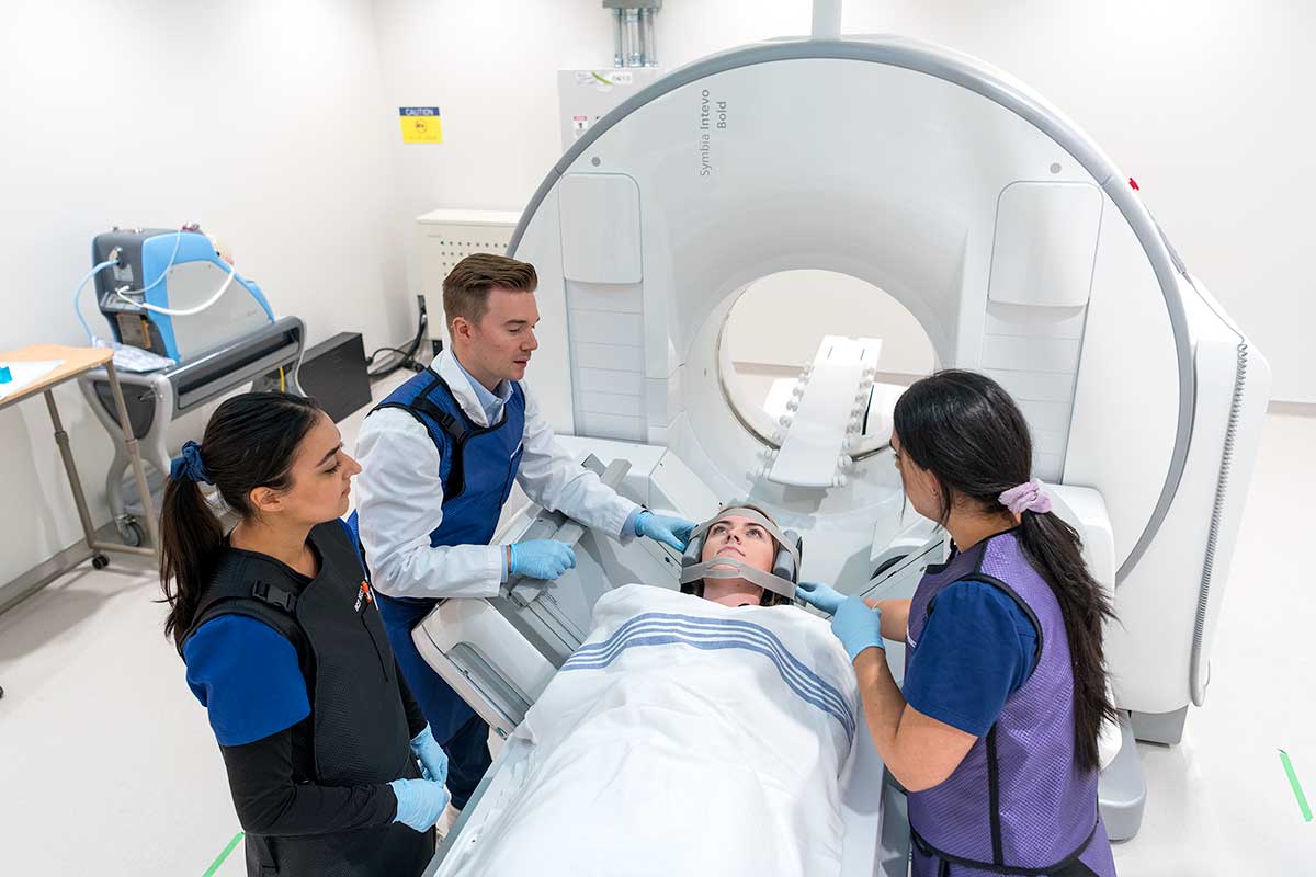 BCIT instructor, students , and patient in nuclear medicine gamma camera