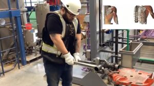 man in hard hat and hi vis vest demonstrating piping safety