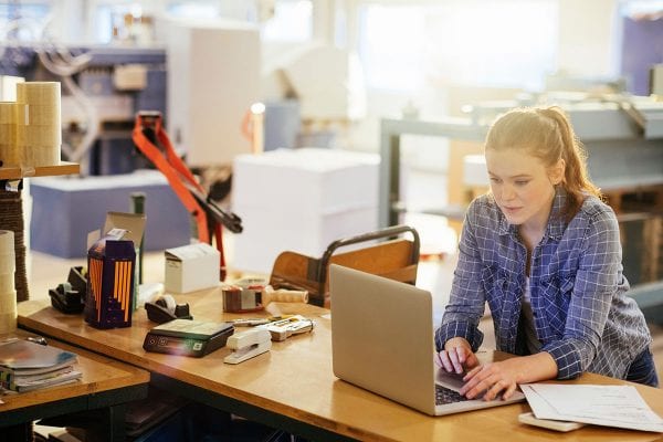 Photo of a young woman in printing factory