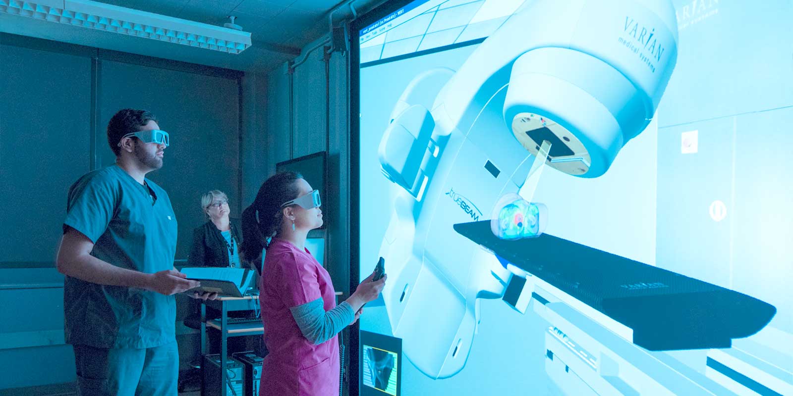 BCIT radiation therapy instructor and students using VERT machine.