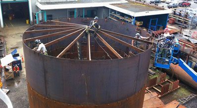 Working on a large boiler as part of boilermaker training at BCIT