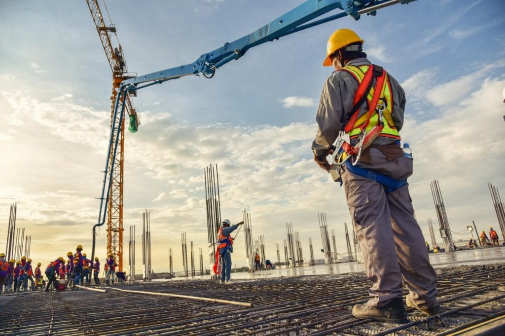 man with a helmet looking at crane