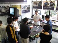 five male students stood around a table with mechanical items on it