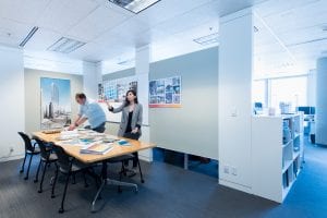 Interior Design students look at product samples in a creative space