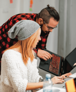 Two students looking at a laptop.