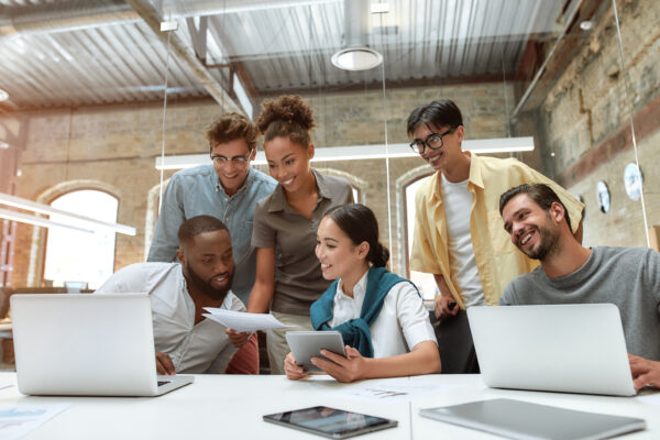 We have great results! Group of young cheerful business people in casual wear working together on new project while sitting in the creative office