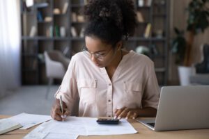 Female student works on a budget worksheet