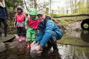 Mark Angelo releases juvenile chum salmon into Guichon Creek with his grandson (and a class of children from the BCITSA daycare.