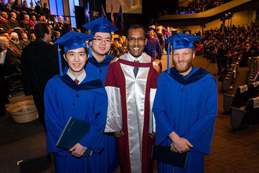 Fitsum with three graduate students at convocation