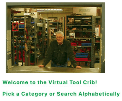 Photo of man standing at the counter of a shop with rows of shelves filled with tools