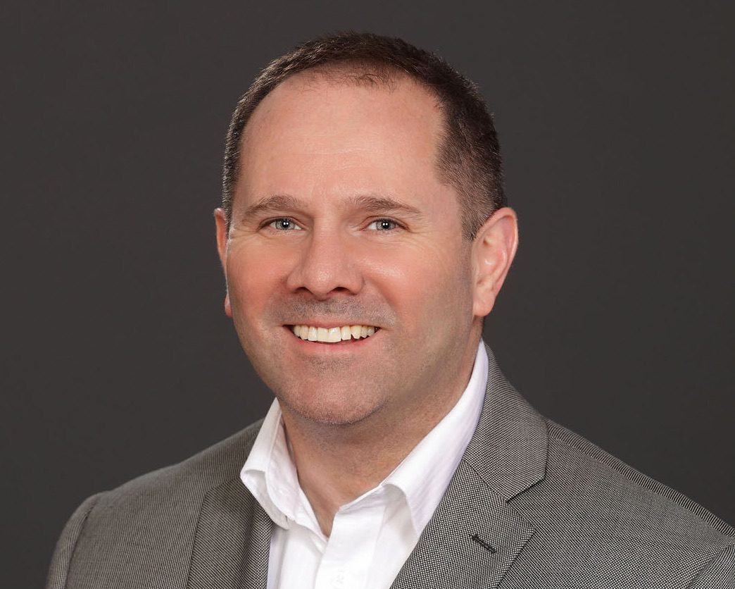 a man in a white dress shirt and gray suit