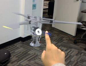 virtual image of helicopter in a room with a man's hand in front