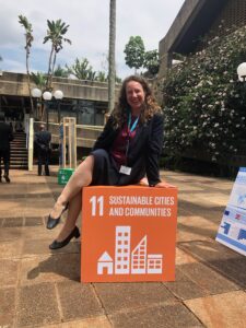 Dr. Jennie Moore Director of Institute Sustainability at BCIT sitting on the SDG 11 Sustainable Cities and Communities cube.